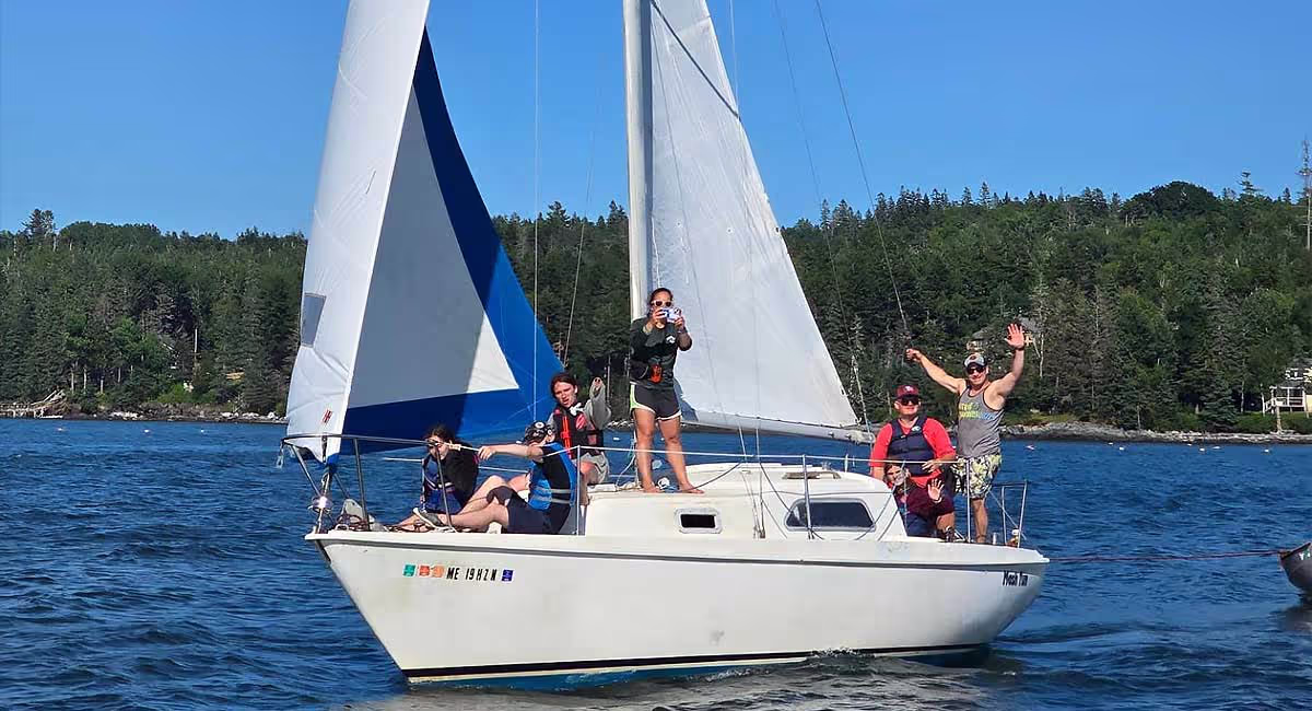 Adventurelore campers sailing along the Maine coast