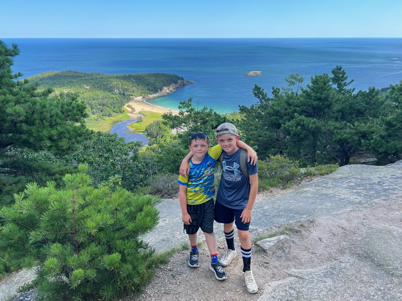 Two Adventurelore campers smiling together at a coastal overlook