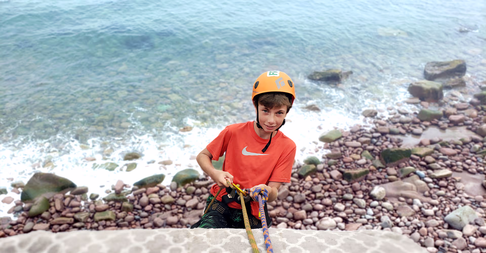 An Adventurelore participant preparing to climb beside the river