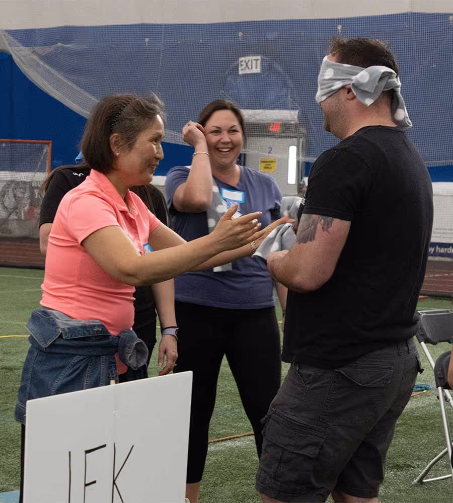 Adults taking part in a team building activity